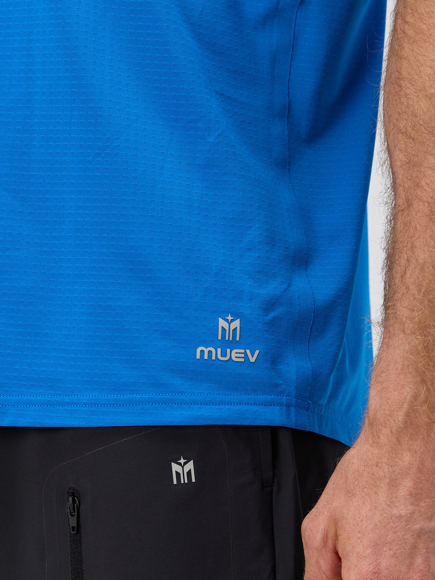 Close-up of man wearing royal blue lightweight moisture-wicking performance tee paired with black athletic shorts, styled for pickleball apparel.