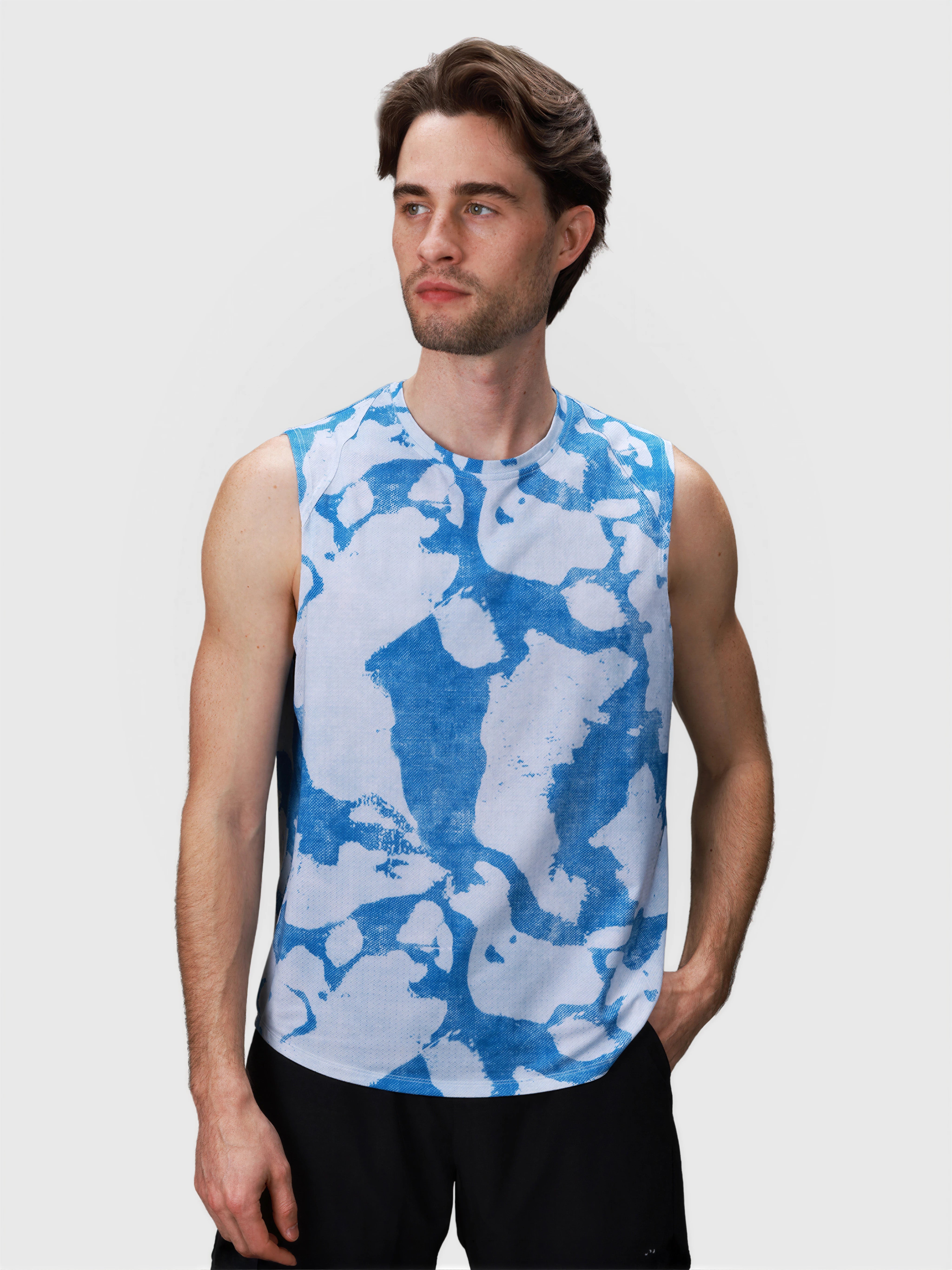 Man wearing blue and white Digital Camo Dink Tank in pickleball apparel by MUEV with sleeveless design