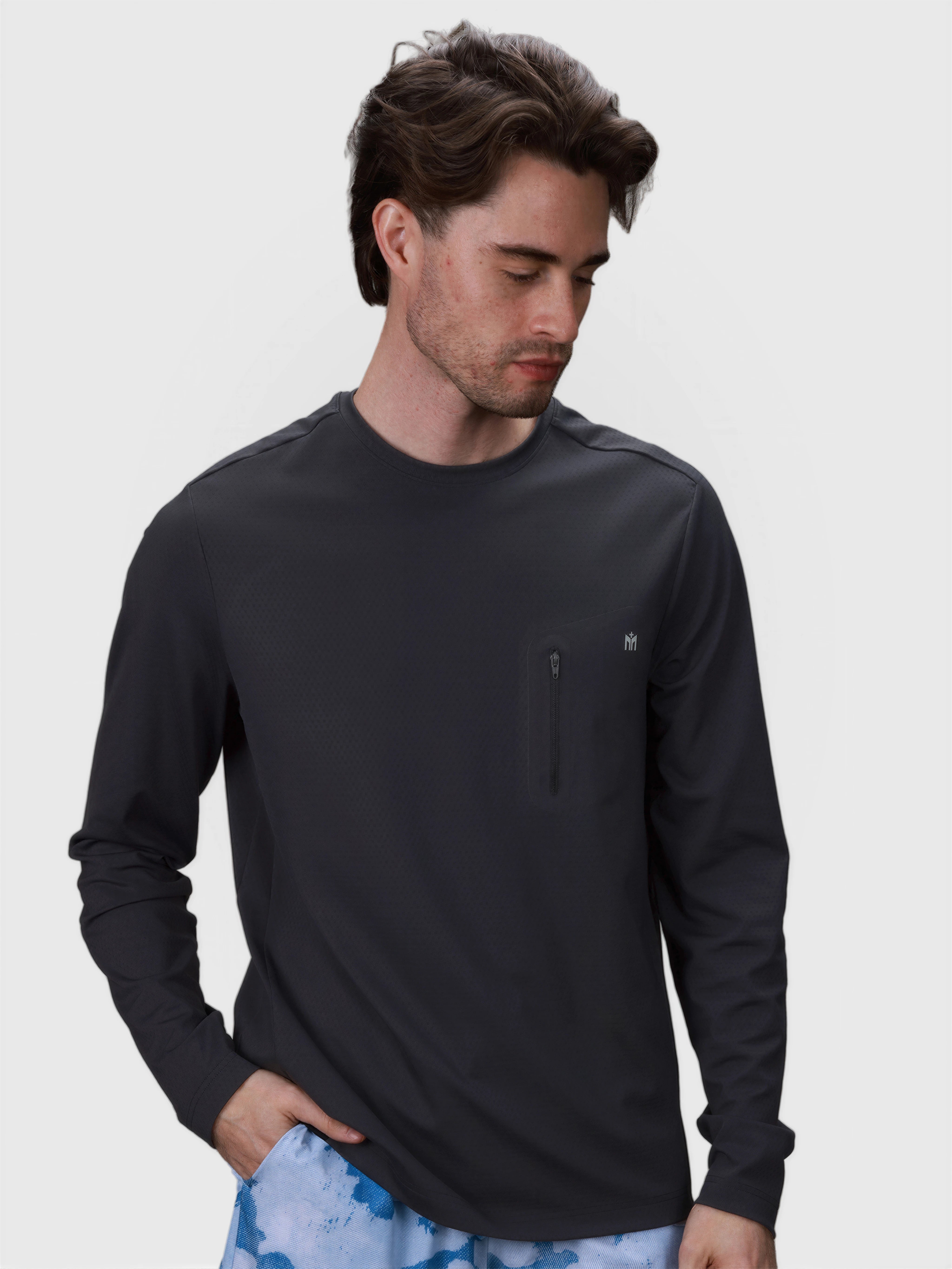 Man wearing black Echelon Long Sleeve Shirt by MUEV with zippered chest pocket for padel and pickleball clothing