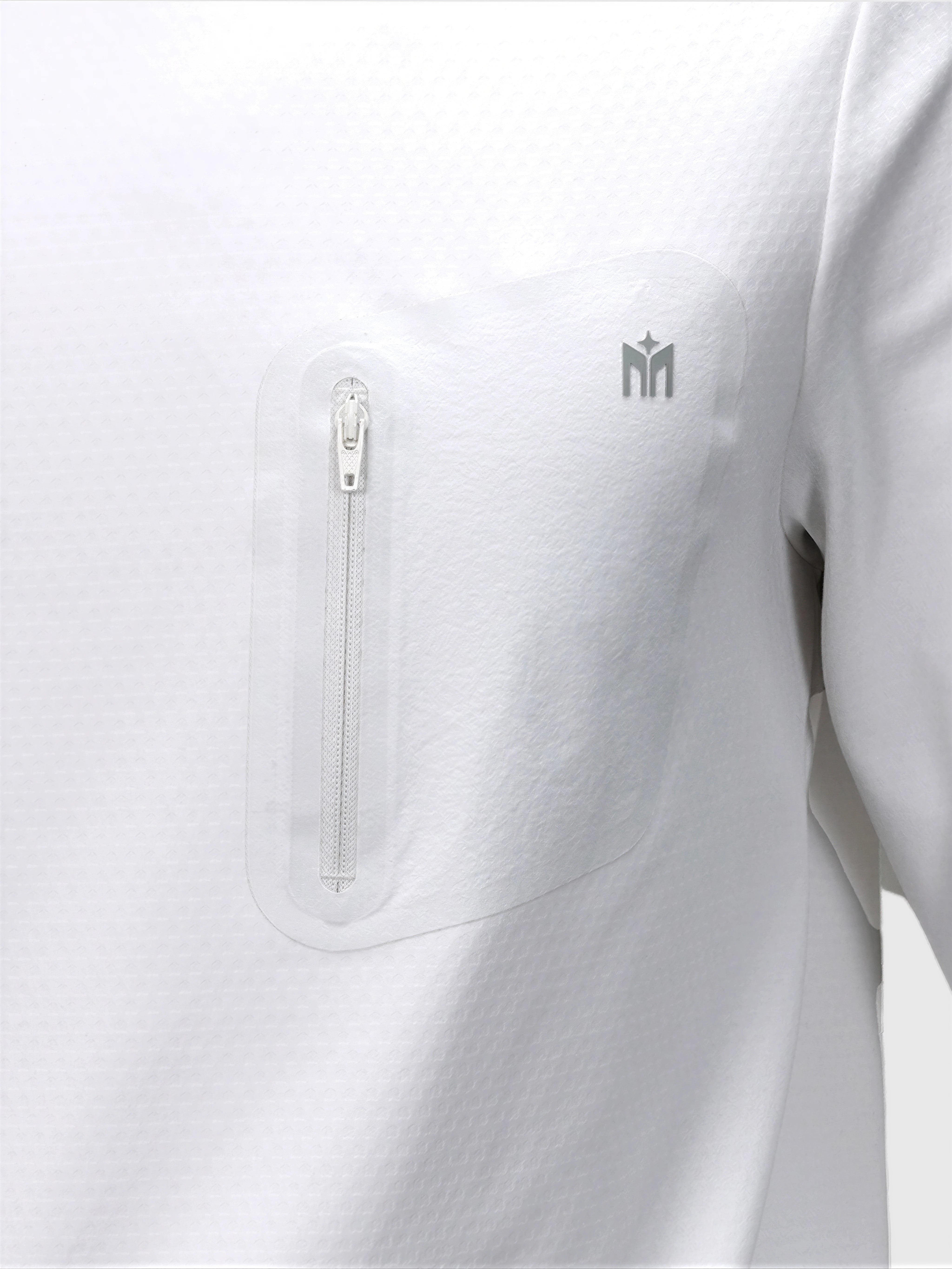 Close-up of white Echelon Long Sleeve Shirt by MUEV featuring a zippered chest pocket for padel and pickleball apparel
