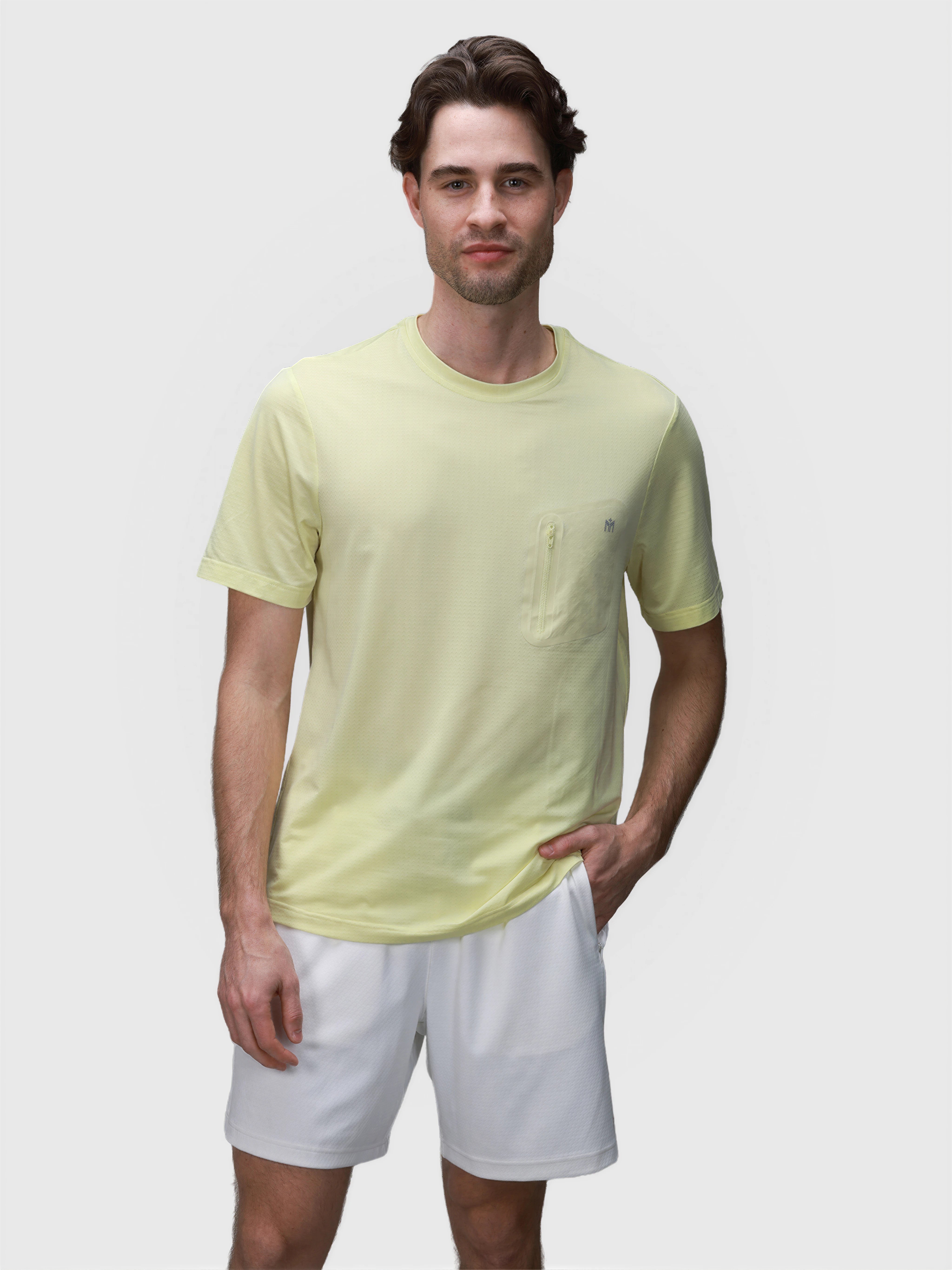 Man wearing white Echelon Short by MUEV paired with light yellow shirt for padel and pickleball clothing