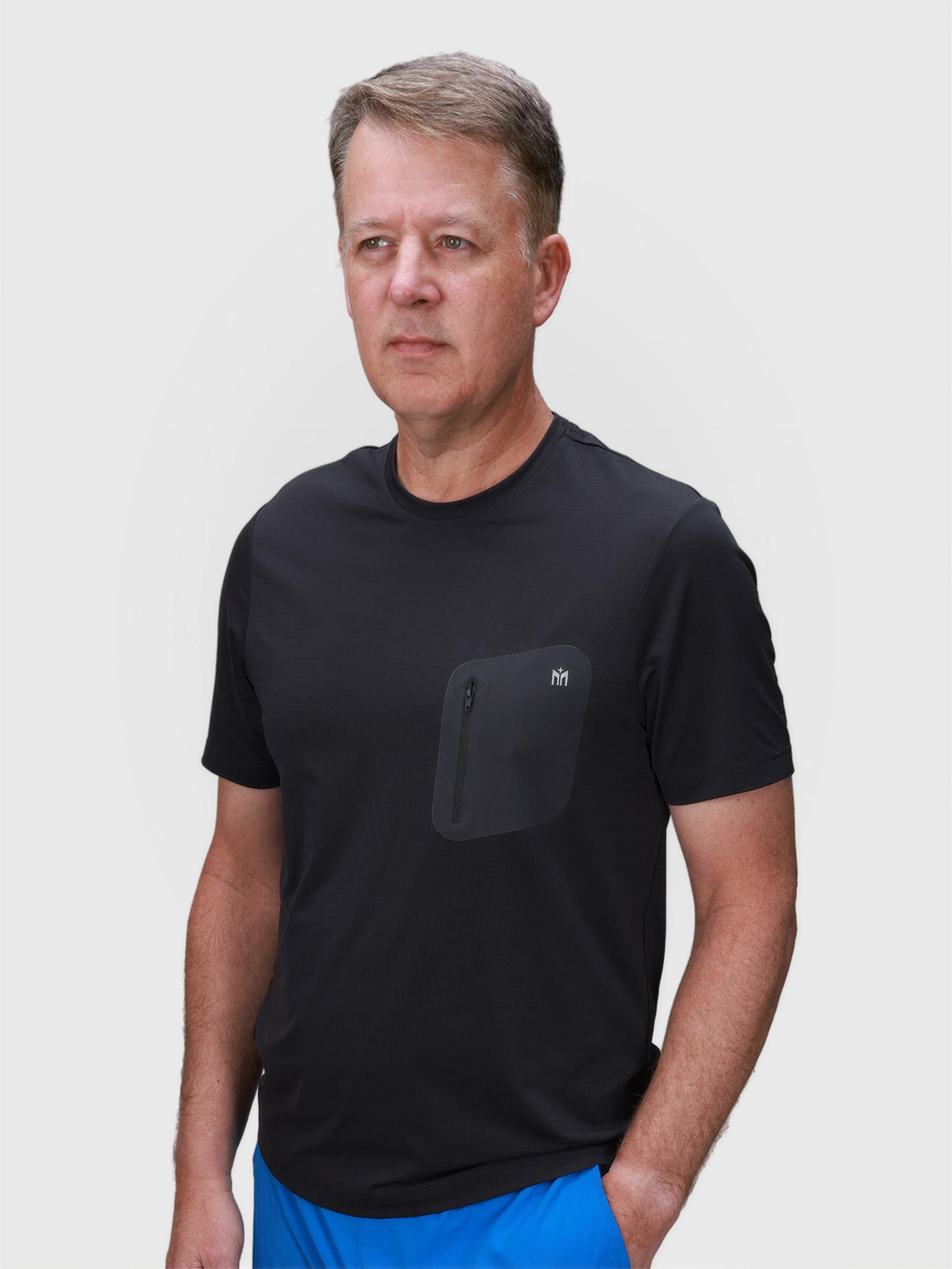 Man wearing black Flex Bonded Pocket Tee by MUEV designed for lightweight padel and pickleball apparel comfort
