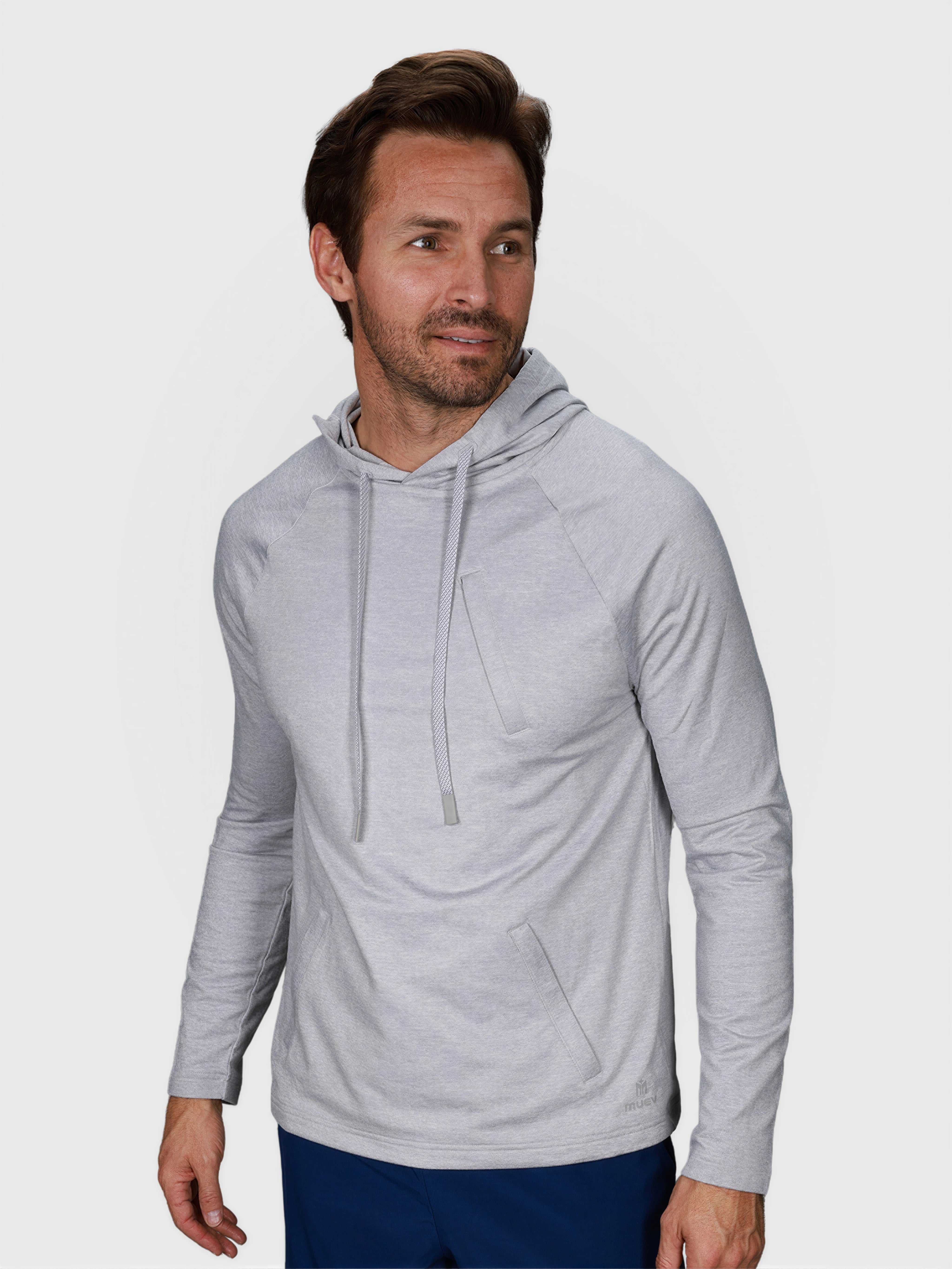 Man wearing Heather Gray Pro Serve Hoodie by MUEV in relaxed pose for padel and pickleball clothing
