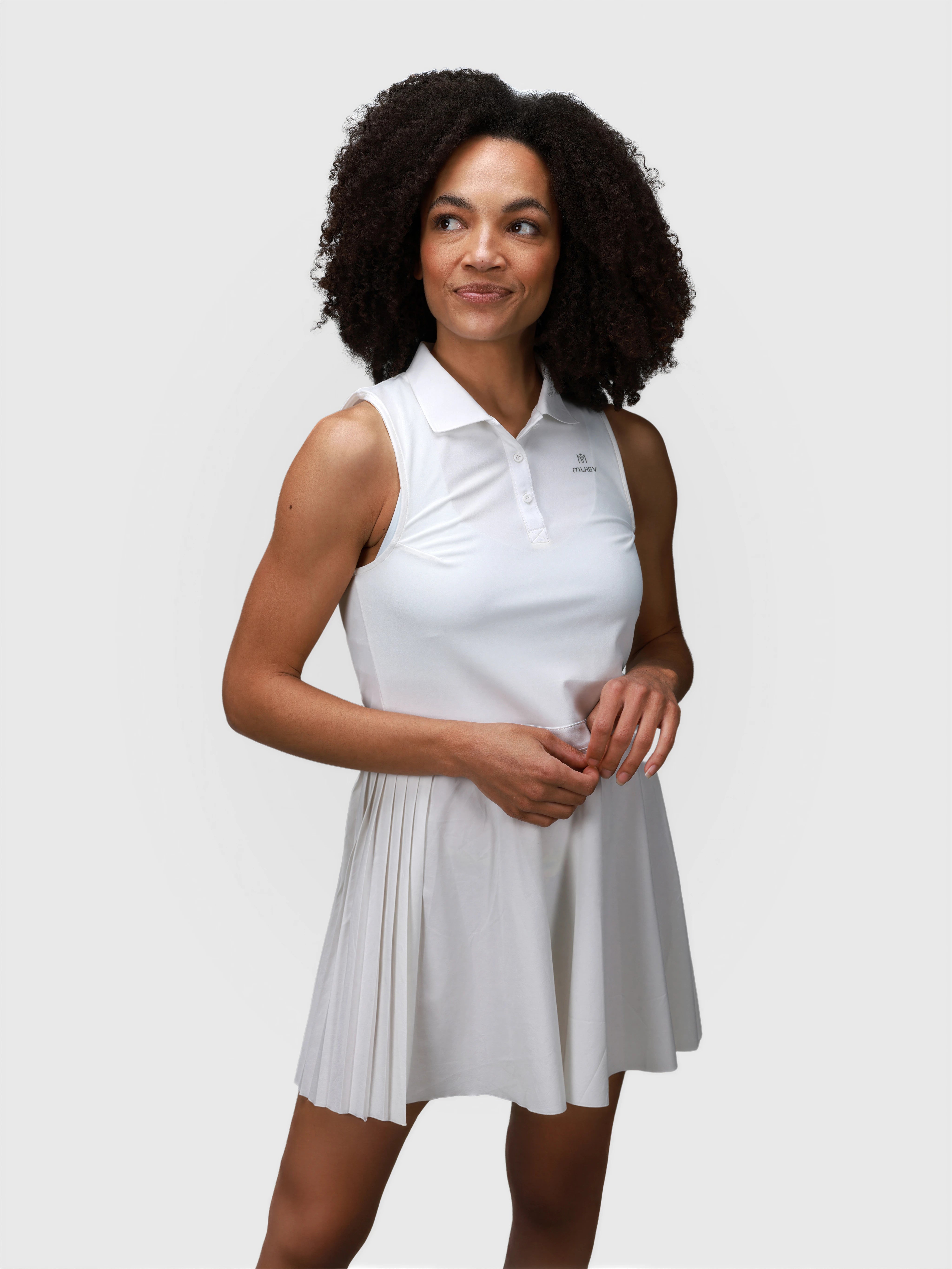 Front view of white Open Back Polo Dress by MUEV with pleated skirt for pickleball and padel apparel