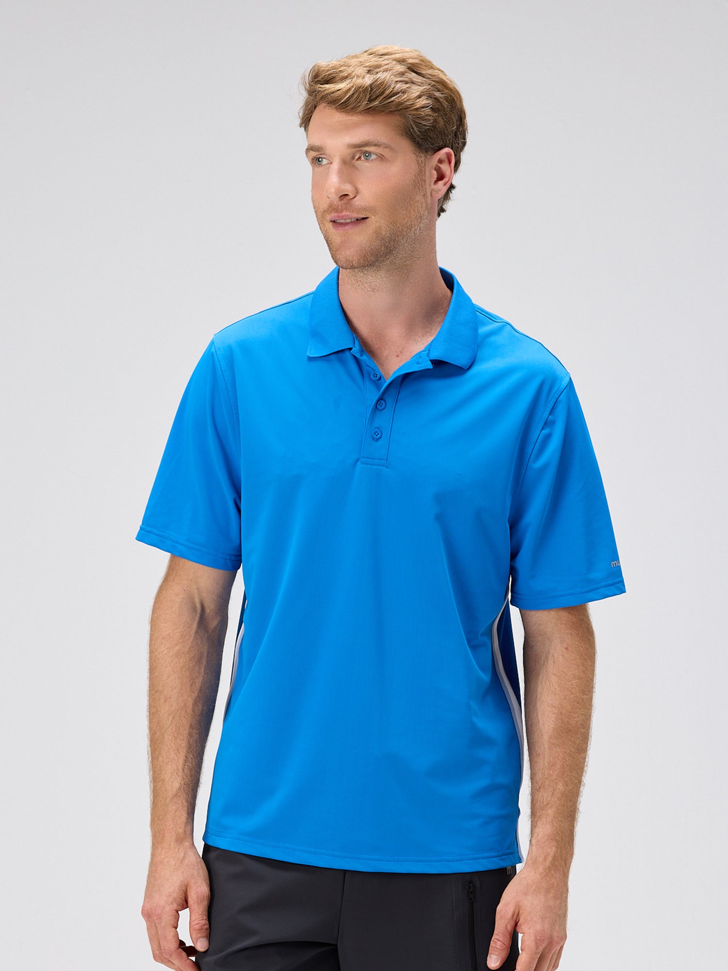 man wearing royal blue polo shirt with moisture-wicking fabric and 4-way stretch designed for pickleball and padel apparel