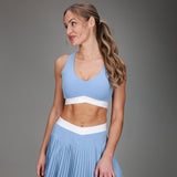front of blue tanklette and blue pleated skirt 