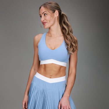front of blue tanklette and blue pleated skirt 