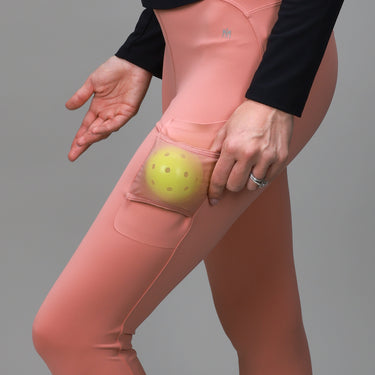 side view of p[ink leggings with side pocket for ball