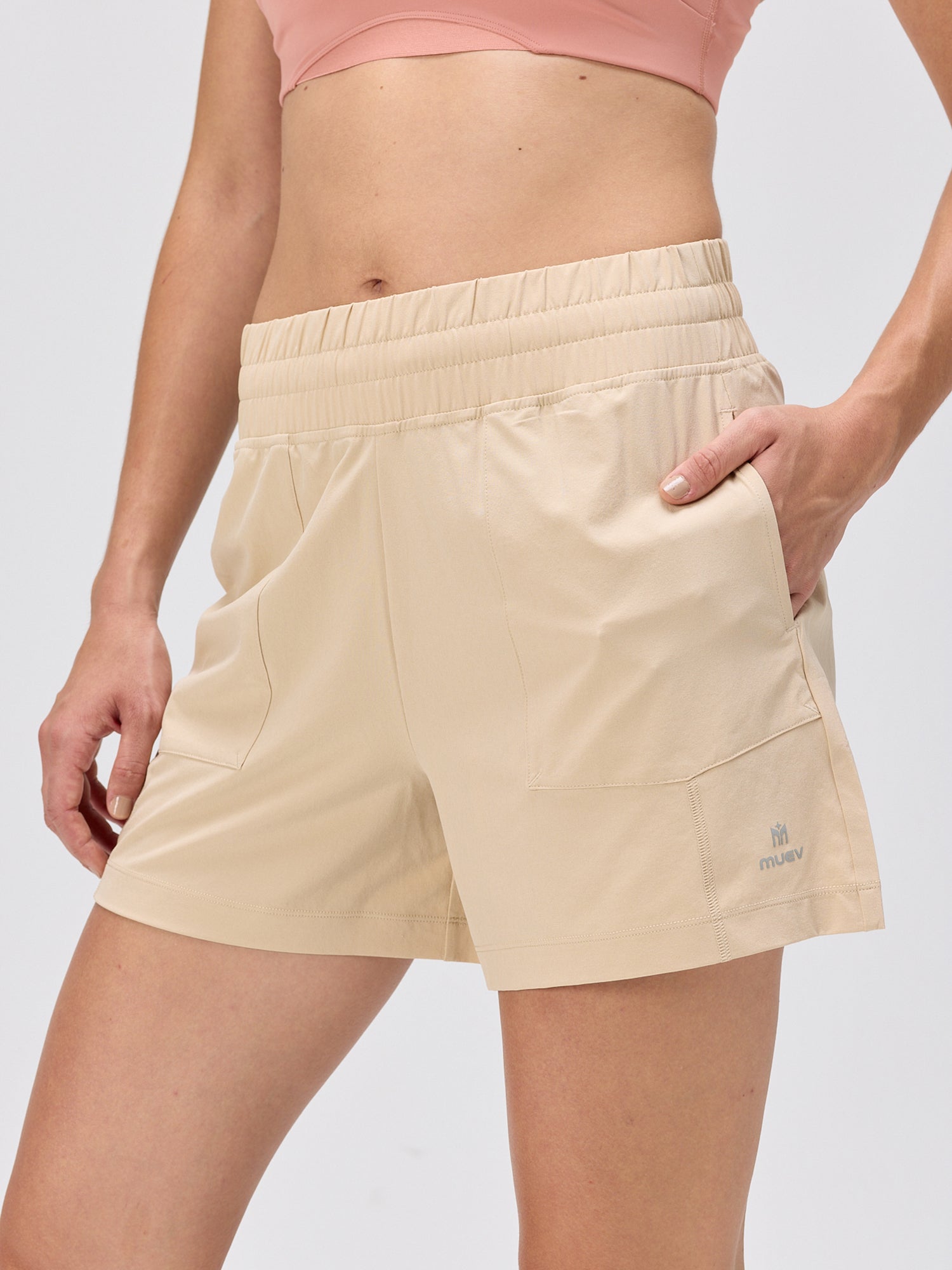 Close-up of khaki moisture-wicking shorts with an elastic waistband and front pockets, designed for pickleball and padel by MUEV