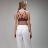 back of white pleated pant and plum bra 