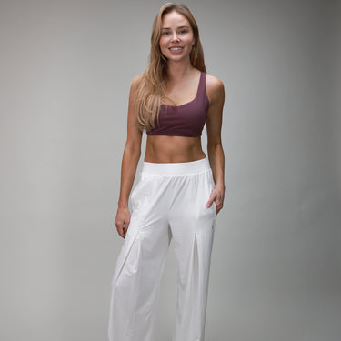 front of white pleated pant and plum bra
