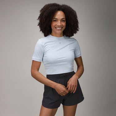front of black tulip short and light blue crop tee 