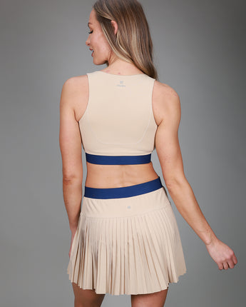 back of khaki tanklette and khaki pleated skirt 