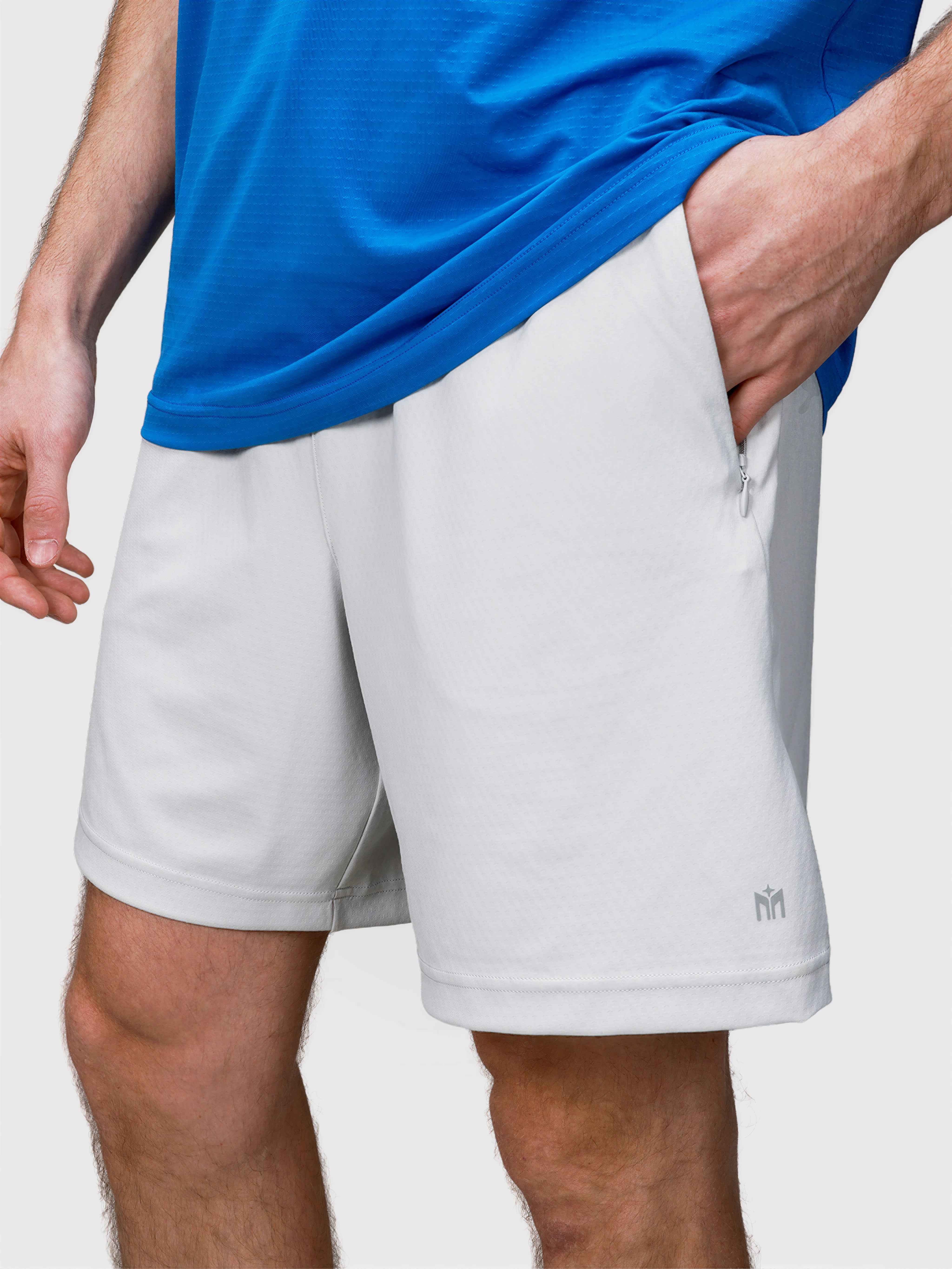 Close-up of white Echelon Short by MUEV with zippered side pocket for padel and pickleball apparel