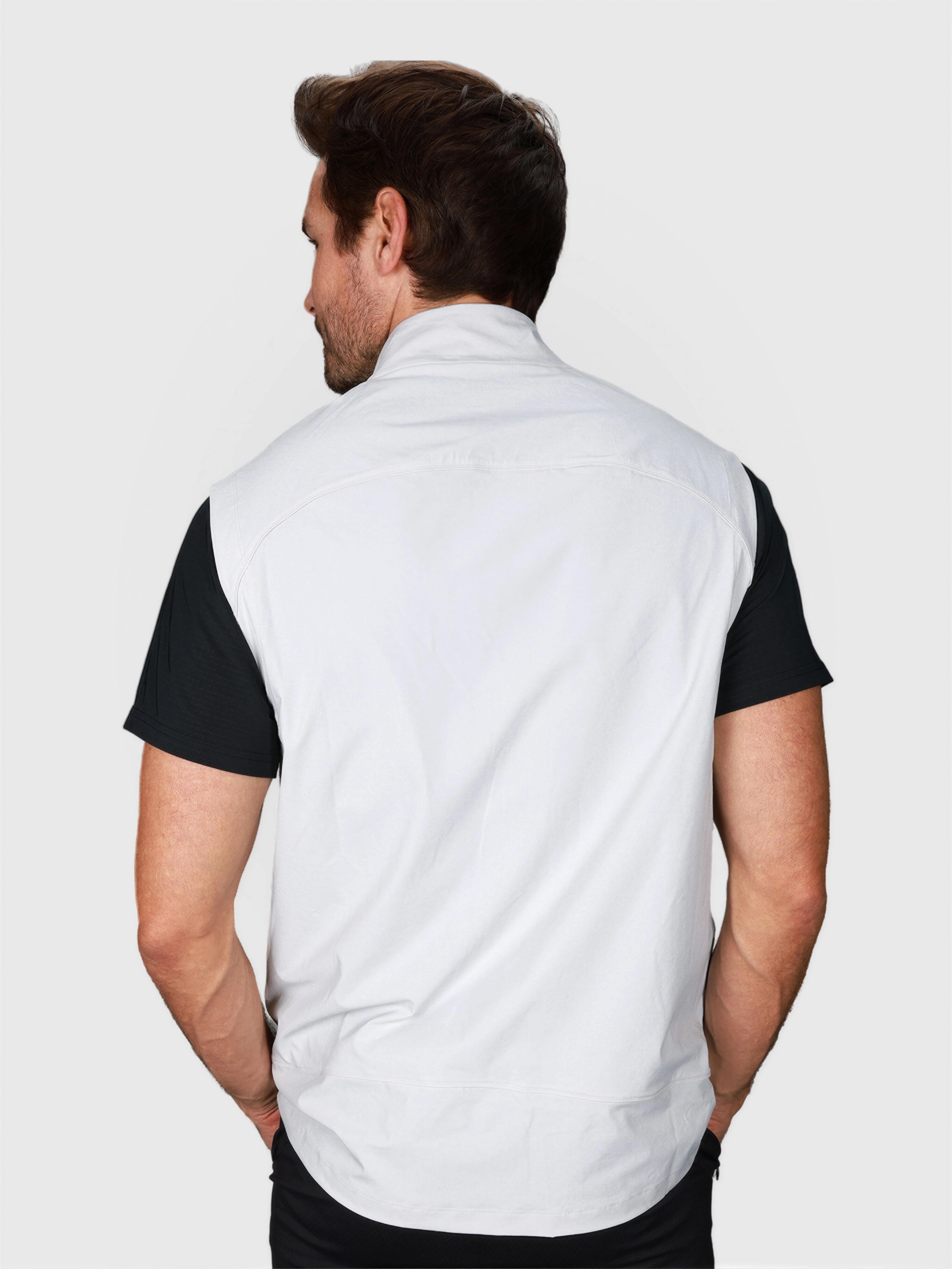Man shown from back wearing white J Sas Vest by MUEV designed for padel and pickleball clothing