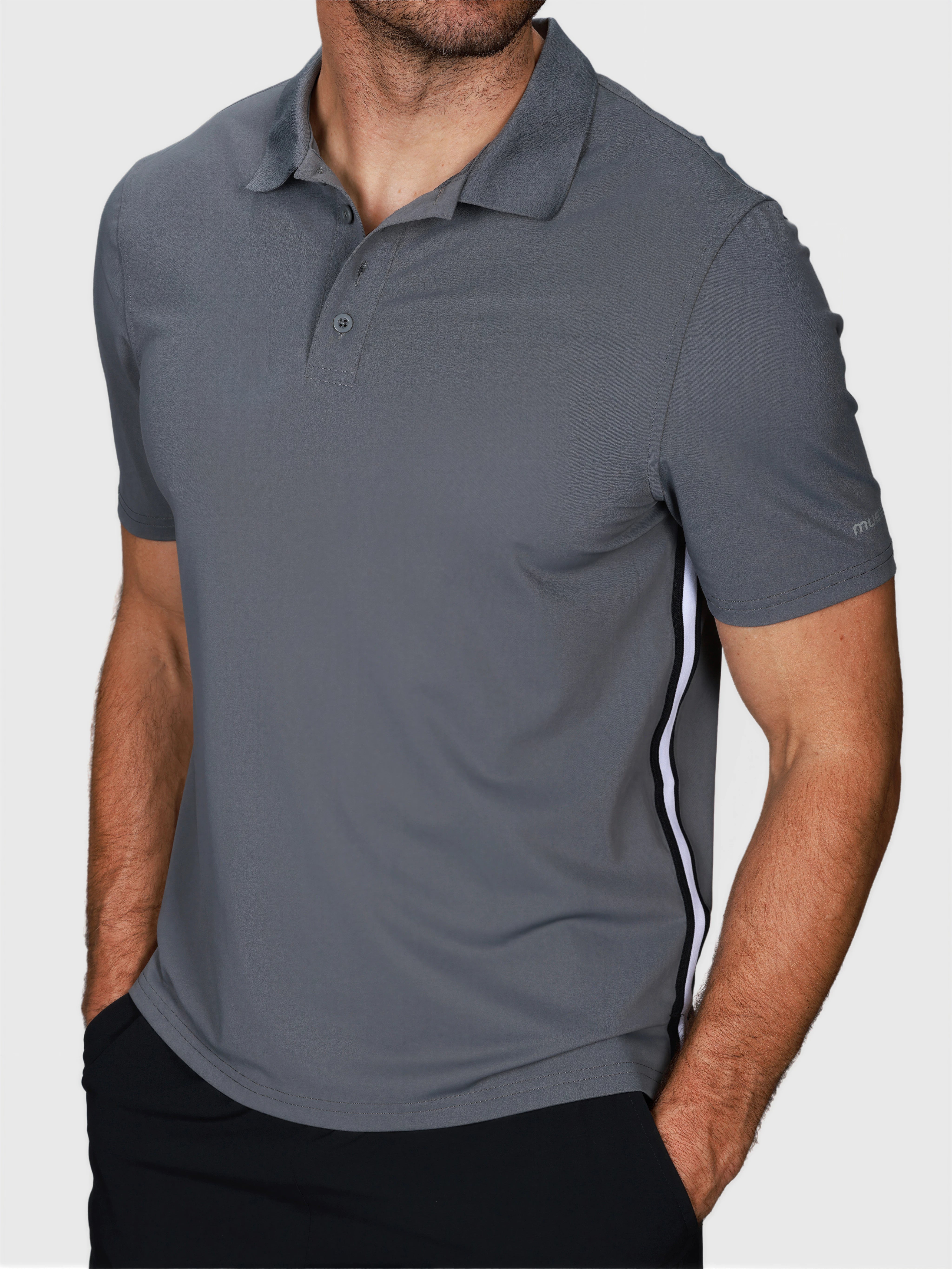 Man wearing Pewter Gray Tip Polo by MUEV with white side stripes for padel and pickleball apparel