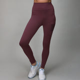 plum colored leggings with side and back pocket for ball 
