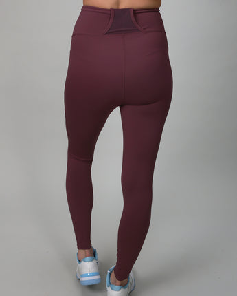 plum colored leggings with side and back pocket for ball