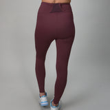 plum colored leggings with side and back pocket for ball 