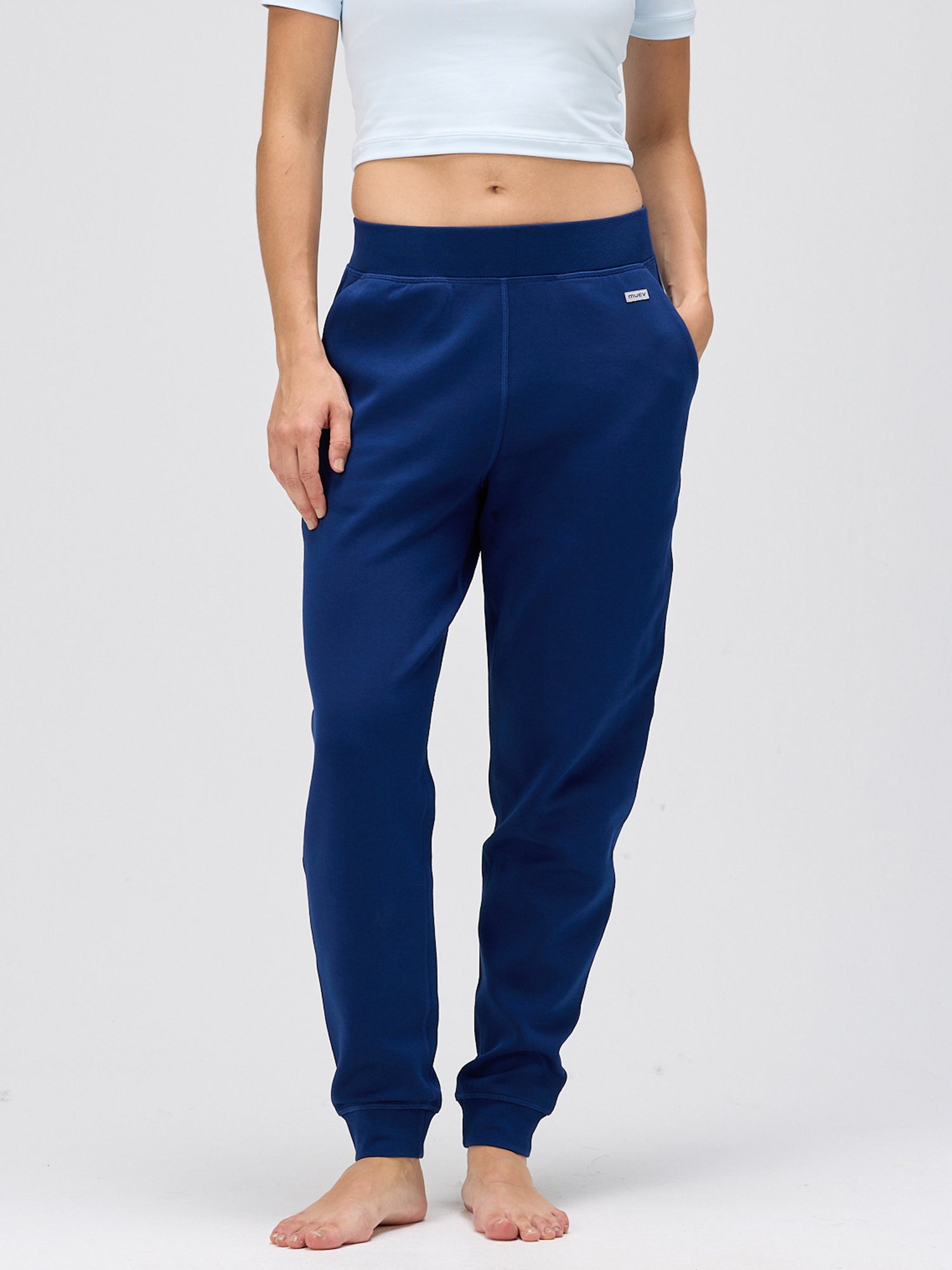 woman wearing navy comfortable resort pants with elastic waistband and pockets, styled for casual padel and pickleball apparel