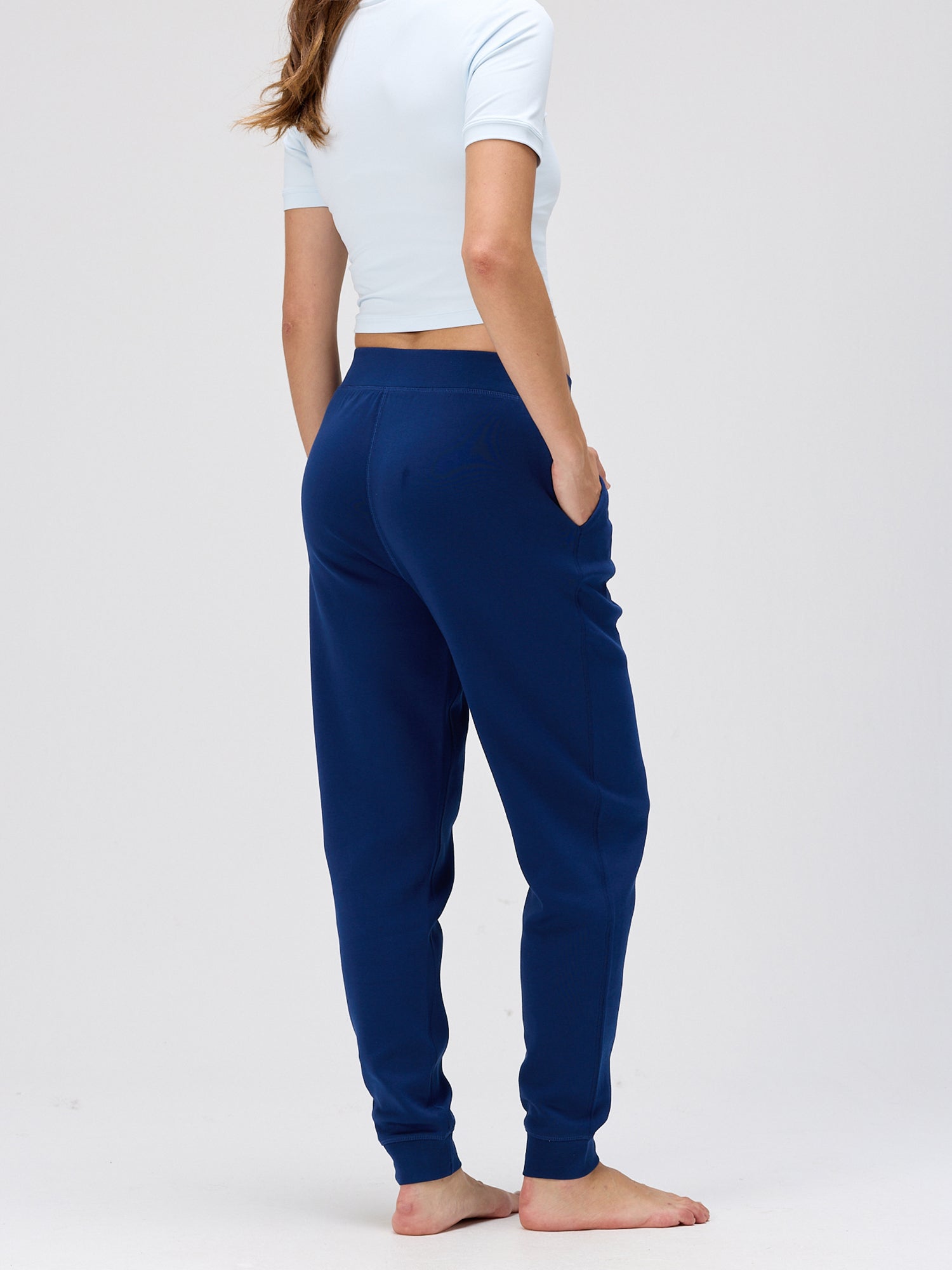 woman wearing navy resort pants with a relaxed fit and elastic cuffs styled for comfortable activewear and casual leisurewear