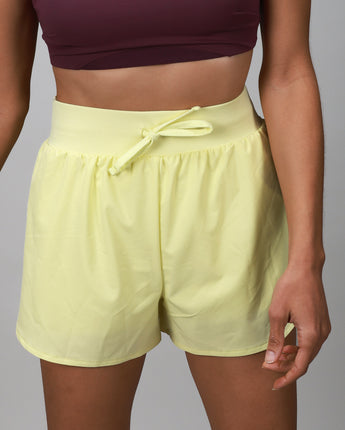 Yellow compression short with outer layer